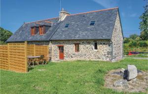 a stone house with red doors and a roof at Amazing Home In Minihy Treguier With 1 Bedrooms And Wifi in Minihy-Tréguier