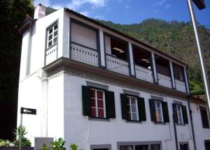 a white building with a balcony on top of it at Holidays Madeira in São Vicente