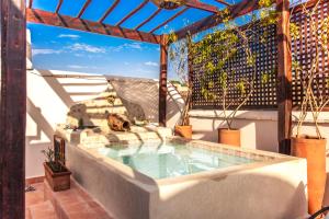 a swimming pool on a patio with potted plants at Riad Chams Marrakech in Marrakesh