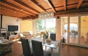 a dining room with a table and a chandelier at Beautiful Home In Codena With Jacuzzi in Carrara