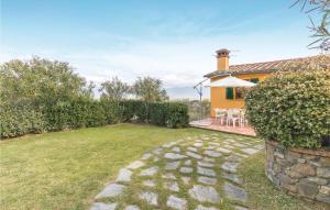 a garden with a stone path in front of a house at Beautiful Home In Casalguidi Pt in Cantagrillo