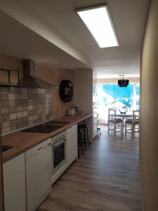 a kitchen with a sink and a stove top oven at CHECK-IN CASAS El rinconet in Cerler