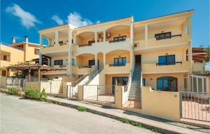 an apartment building with stairs in front of a street at Lotar in Castelsardo