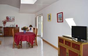 a living room with a table with a red table cloth at Amazing Home In Meslan With Kitchen in Meslan