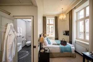 a hotel room with a bed and a bathroom at Astoria Hotel in Lviv