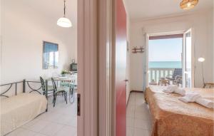 a bedroom with a bed and a view of the ocean at Le Vele in Marotta