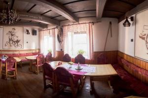 a dining room with tables and chairs and a window at Motel pod Stromíšom in Vlachovo