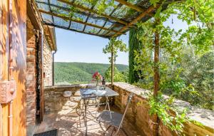 a patio with a table and chairs on a stone wall at 2 Bedroom Nice Apartment In Ambra Ar in Badia a Ruoti