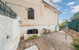 a patio with two chairs and a fireplace on a building at Casa Mare in Magomadas