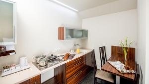 a kitchen with a counter and a table in a room at Astoria Hotel in Lviv