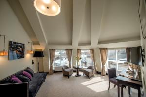 a living room with a couch and a table at Astoria Hotel in Lviv