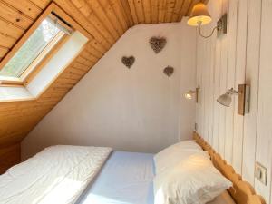 a small bedroom with a bed in a attic at Le 103. Chalet 3 chambres. Terrasse. Parking. wifi. in Cauterets
