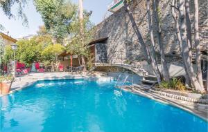 a swimming pool in front of a stone building at Il Veliero in Rapallo