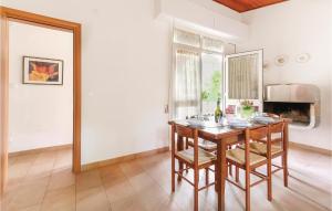 a dining room with a wooden table and chairs at Casa Laura 1 in Lignano Sabbiadoro