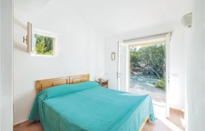 Un dormitorio con una cama con una manta azul. en Casa Allegra, en Costa Paradiso
