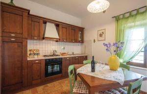 a kitchen with a table with a vase of flowers on it at Zafferano 1 in San Gimignano