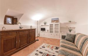 a living room with a couch and a tv at Casa Chiara in Gaiole in Chianti