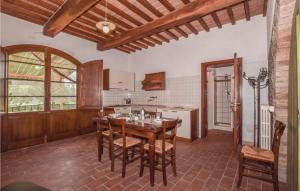 a large kitchen with a wooden table and chairs at Casina in Collelungo