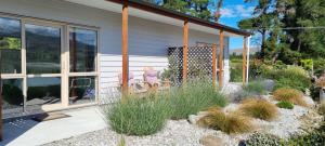 a house with a garden with plants in front of it at Lodges On Pearson Unit 1 in Cromwell