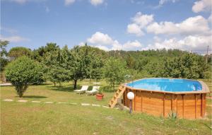 a large wooden hot tub in a field with trees at Polla in Cerasomma