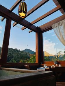 a room with a large window with a view of mountains at I'Lumiar Loft in Lumiar