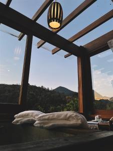 a bedroom with a window with a view of the mountains at I'Lumiar Loft in Lumiar