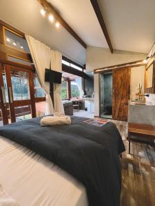 a bedroom with a large bed and a bathroom at I'Lumiar Loft in Lumiar