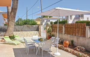 a patio with a table and chairs and an umbrella at Casa Villa Carla in Palma de Mallorca