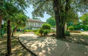 a walkway in front of a house with palm trees at 6 Bedroom Cozy Home In Rimini in Rimini