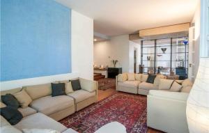 a living room with two couches and a blue wall at 6 Bedroom Cozy Home In Rimini in Rimini