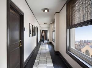 a hallway with a large window and a large mirror at The Clift Royal Sonesta Hotel in San Francisco