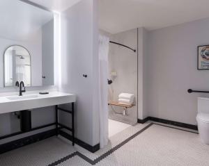 a bathroom with a shower, sink, and mirror at The Clift Royal Sonesta Hotel in San Francisco