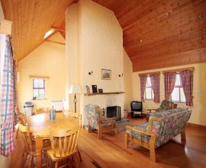a living room with a table and a dining room at Fanore Holiday Cottages in Ballyvaughan