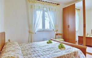 a bedroom with a bed with green slippers on it at Casa Antonia in Castellabate
