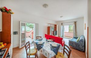 a dining room with a table and chairs in a room at Stunning Apartment In La Maddalena With House A Panoramic View in La Maddalena