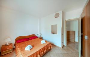 a bedroom with a bed with red pillows at Stunning Apartment In La Maddalena With House A Panoramic View in La Maddalena