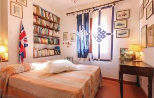 a bedroom with a bed and a desk and a book shelf at Villa Eugenia in Favazzina