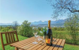 una bottiglia di vino e un bicchiere su un tavolo di legno di Awesome Home In Belluno Bl With Wifi a Lèvego