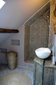 a bathroom with a sink and a shower at Attic Room Judy's in Zandvoort