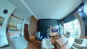 a living room with a couch and a table at EagleNest at Iris House Resort in Tanah Rata