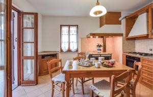 uma cozinha com uma mesa de madeira e cadeiras em Casa Giovanni em Tavarone