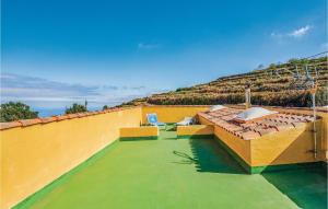 a roof with two chairs and a hill in the background at Gorgeous Home In Icod El Alto With Kitchen in Icod el Alto