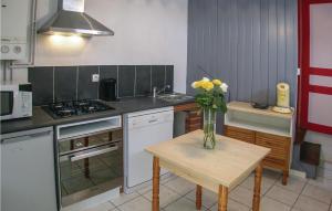 a kitchen with a table with a vase of flowers on it at Beautiful Home In Auxi Le Chteau With Wifi in Auxi-le-Château