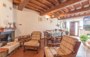 a living room with a fireplace and a table and chairs at Il Frantoio in Loro Ciuffenna