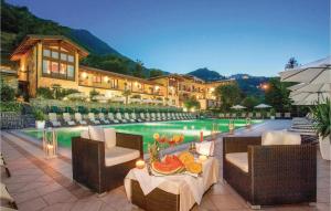 a resort with a swimming pool with chairs and a table at Residence Le Rose in Tremosine Sul Garda