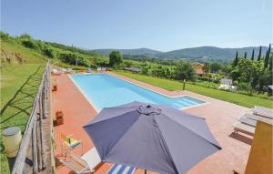 an umbrella is sitting next to a swimming pool at Borgo Vepri F2 in Capannole