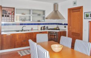 a kitchen with a table and chairs and a sink at Borgo Vepri F2 in Capannole