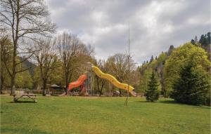 a park with three slides in the grass at Nice Apartment In La Bourboule With 1 Bedrooms in Le Mont-Dore