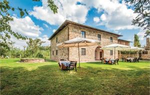 a building with tables and umbrellas in front of it at Dahlia in Lucolena in Chianti