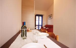 a bottle of wine sitting on a table in a room at Beautiful Apartment In Costa Rei -Ca- With Wifi in Monte Nai